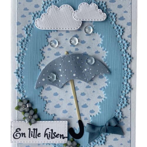 Det perfekte lykønskningskort til barnedåben, med en lille blå paraply og de små regndråber